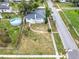 Aerial view of a single-story house with above ground pool and yard at 117 W Maple St, Davenport, FL 33837