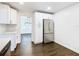 Modern kitchen with white cabinets and stainless steel refrigerator at 117 W Maple St, Davenport, FL 33837