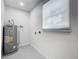 Laundry room with window, vinyl flooring and water heater at 117 W Maple St, Davenport, FL 33837