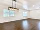 Spacious dining area with dark hardwood floors and a modern light fixture at 117 W Maple St, Davenport, FL 33837