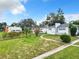 Single-story home exterior with gray roof, white siding and landscaping at 117 W Maple St, Davenport, FL 33837