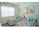 Bedroom with two twin beds and colorful bedding at 4839 Kings Castle Cir, Kissimmee, FL 34746