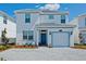 Two-story house with a two-car garage and landscaped front yard at 4839 Kings Castle Cir, Kissimmee, FL 34746