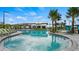 Community pool with lounge chairs and palm trees at 4839 Kings Castle Cir, Kissimmee, FL 34746