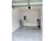 Empty garage with light-colored floor and overhead light at 114 Mandovi St, Davenport, FL 33837