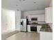 Kitchen with white cabinets, stainless steel appliances, and granite countertops at 114 Mandovi St, Davenport, FL 33837
