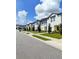 Row of townhouses with light-colored siding and landscaping at 114 Mandovi St, Davenport, FL 33837