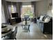 Living room with gray sofa and wood-look floors at 6402 Parc Corniche Dr # 5208, Orlando, FL 32821