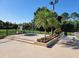 Community hot tub with surrounding lounge chairs at 6402 Parc Corniche Dr # 5208, Orlando, FL 32821
