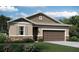 One-story home with brown garage door and landscaping at 2103 Riley Ave, Eagle Lake, FL 33839