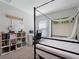 Bedroom with canopy bed, workspace, and built-in shelving at 4743 Magnetite Loop, Mount Dora, FL 32757