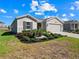 House exterior with a two-car garage and landscaping at 4743 Magnetite Loop, Mount Dora, FL 32757