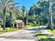 Gated community entry with palm trees and landscaping at 4743 Magnetite Loop, Mount Dora, FL 32757