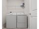 Bright laundry room with washer, dryer, and shelving at 4743 Magnetite Loop, Mount Dora, FL 32757
