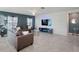 Spacious living room with comfortable seating and a 3D accent wall at 4743 Magnetite Loop, Mount Dora, FL 32757