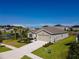 House exterior with a two-car garage and landscaping at 4743 Magnetite Loop, Mount Dora, FL 32757