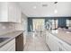 Modern kitchen with white cabinets and gray countertops at 4743 Magnetite Loop, Mount Dora, FL 32757