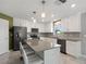 Open kitchen with large island, stainless steel appliances, and ample counter space at 4743 Magnetite Loop, Mount Dora, FL 32757