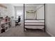 Bedroom with canopy bed, workspace, and built-in shelving at 4743 Magnetite Loop, Mount Dora, FL 32757