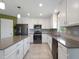 Large kitchen with gray countertops and white cabinets at 4743 Magnetite Loop, Mount Dora, FL 32757