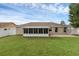 Home exterior showcasing a large backyard and screened porch at 3570 Manor Loop, Lakeland, FL 33810