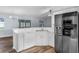 Updated kitchen with stainless steel appliances, white cabinets and a large island at 3570 Manor Loop, Lakeland, FL 33810