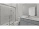 Bathroom with gray vanity, quartz countertop and walk-in shower at 5773 High Seas Dr, Orlando, FL 32821