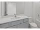 Modern bathroom featuring a gray vanity and a quartz countertop at 5773 High Seas Dr, Orlando, FL 32821
