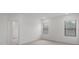 Spacious bedroom with neutral carpeting and two windows at 5773 High Seas Dr, Orlando, FL 32821