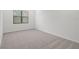 Spacious bedroom with neutral carpeting and large window at 5773 High Seas Dr, Orlando, FL 32821