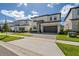 Two-story modern home with gray garage door and stone accents at 5773 High Seas Dr, Orlando, FL 32821