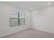 Simple bedroom with gray carpet and window at 5773 High Seas Dr, Orlando, FL 32821