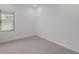 Simple bedroom with gray carpet and window at 5773 High Seas Dr, Orlando, FL 32821