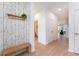 Bright and airy entryway with bench and coat rack at 4683 Terrasonesta Dr, Davenport, FL 33837