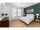 Spacious bedroom with a green accent wall and king-size bed at 4683 Terrasonesta Dr, Davenport, FL 33837