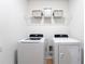 Laundry room with washer, dryer, and wire shelving at 4683 Terrasonesta Dr, Davenport, FL 33837