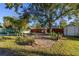 Landscaped backyard with a shed and various plants at 1402 Westminster Way, Kissimmee, FL 34744