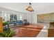 Spacious living room with hardwood floors and large windows at 1402 Westminster Way, Kissimmee, FL 34744