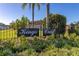 Kings Crest community entrance with a black sign and lush greenery at 1402 Westminster Way, Kissimmee, FL 34744