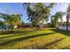 Large backyard with lush grass and landscaping at 1402 Westminster Way, Kissimmee, FL 34744