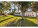 Serene backyard with a large tree providing shade at 1402 Westminster Way, Kissimmee, FL 34744