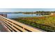 Picturesque lakeside walkway with wooden railings offering tranquil views at 1402 Westminster Way, Kissimmee, FL 34744