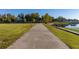 Wide paved walkway next to a lake with green grass and gazebos at 1402 Westminster Way, Kissimmee, FL 34744