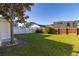 Backyard with white vinyl fence and grass at 1402 Westminster Way, Kissimmee, FL 34744