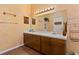 Double vanity bathroom with wood cabinets and tile flooring at 1402 Westminster Way, Kissimmee, FL 34744