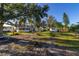 Expansive backyard featuring a large tree and lush grass at 1402 Westminster Way, Kissimmee, FL 34744