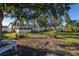 Large backyard with shed, trees, and a wooden bench at 1402 Westminster Way, Kissimmee, FL 34744