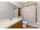 Bathroom with a shower/tub combo and patterned shower curtain at 1402 Westminster Way, Kissimmee, FL 34744
