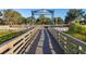 Wooden footbridge leading to a shaded waterfront pavilion at 1402 Westminster Way, Kissimmee, FL 34744
