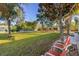 Relaxing backyard with lounge chairs and trees at 1402 Westminster Way, Kissimmee, FL 34744
